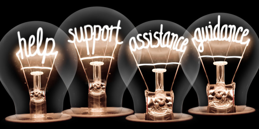 Lightbulbs whose internal filaments seem to write 'help', 'support', 'assistance', and 'guidance'.