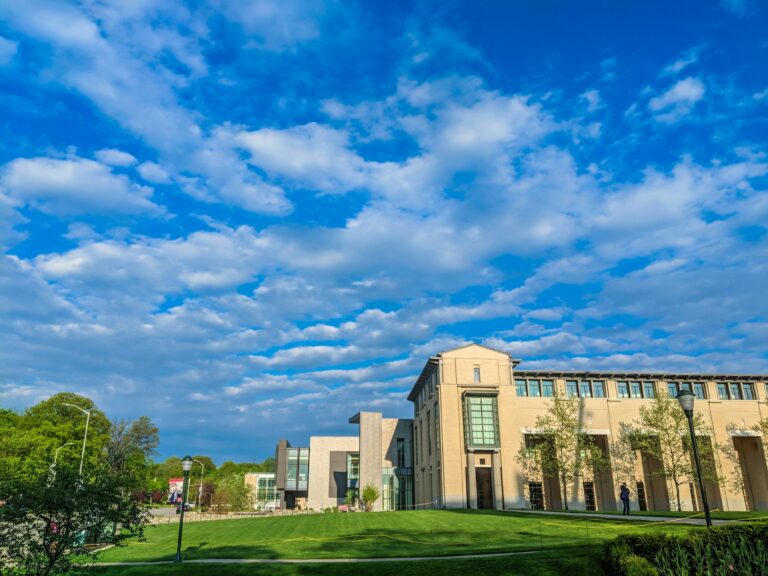 Carnegie Mellon University campus with modern buildings under a bright blue sky with clouds