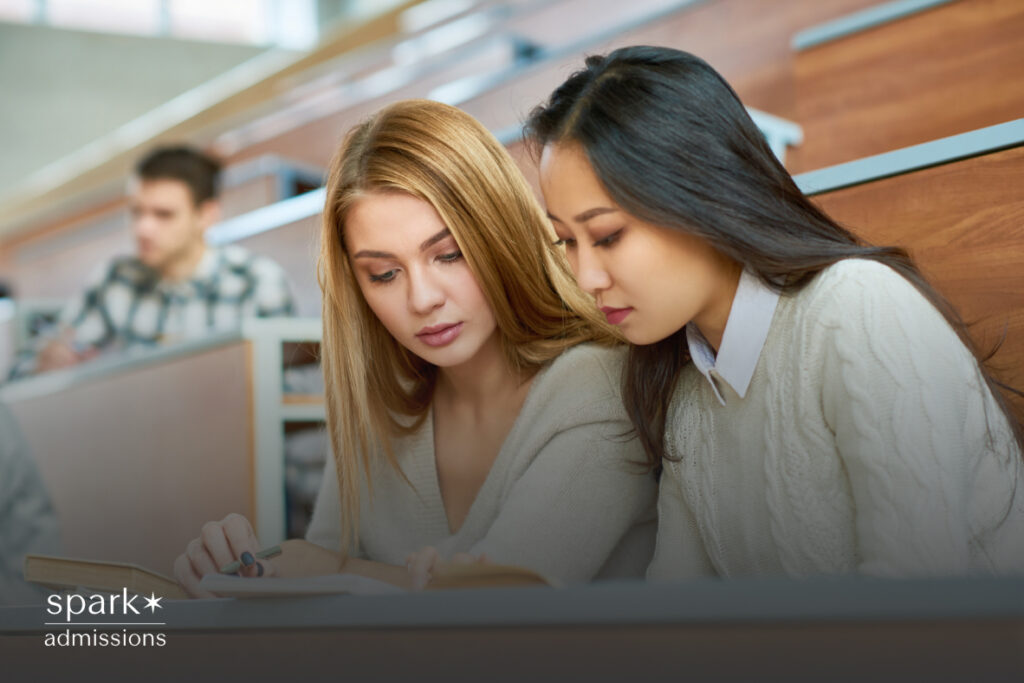 Close-up of a female student reading a book in class, focused and attentive.