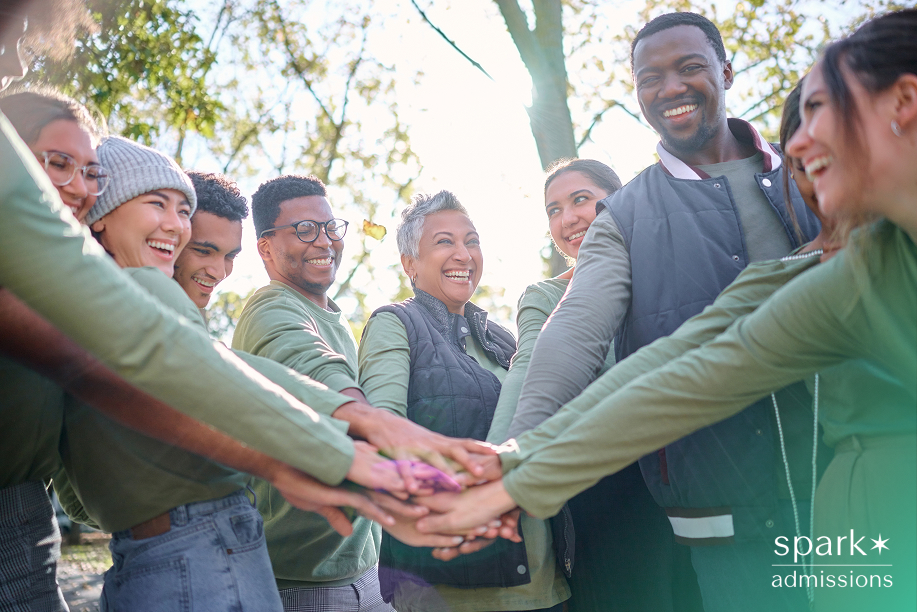 Group of volunteers working together outdoors, illustrating genuine community-focused service that creates meaningful impact beyond voluntourism.